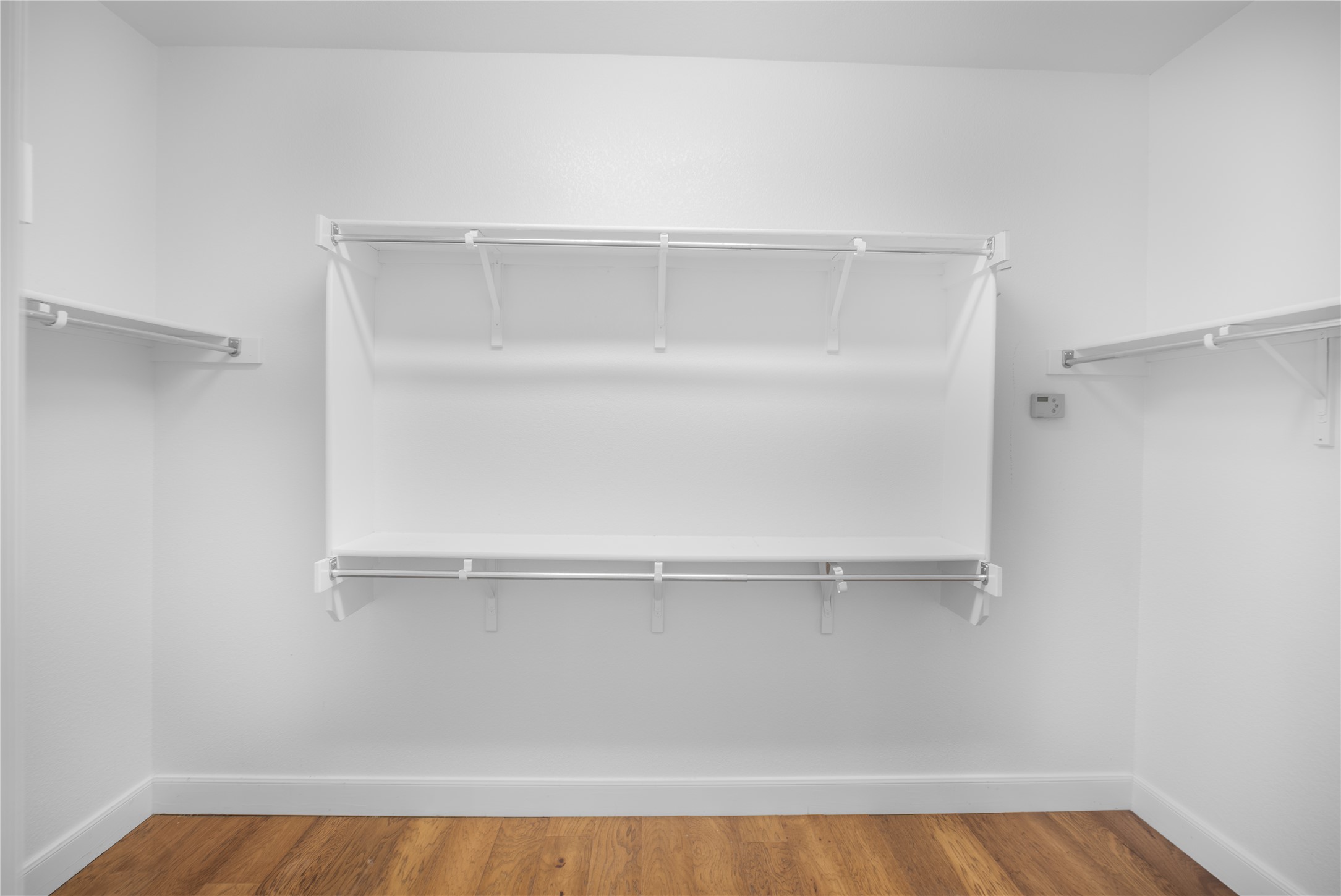 214 Summit Street Georgetown, TX 78633 - Photo 25 of 38 The property features a closet with a built-in shelving system and hardwood floors