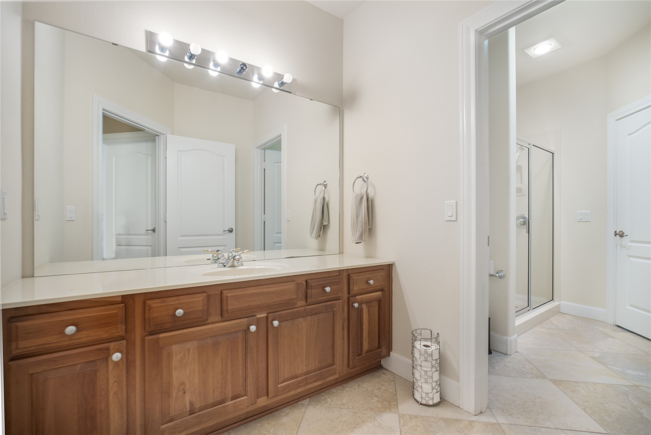 214 Summit Street Georgetown, TX 78633 - Photo 31 of 38 The bathroom features a spacious vanity with wood cabinetry, a light-colored countertop, and a large mirror