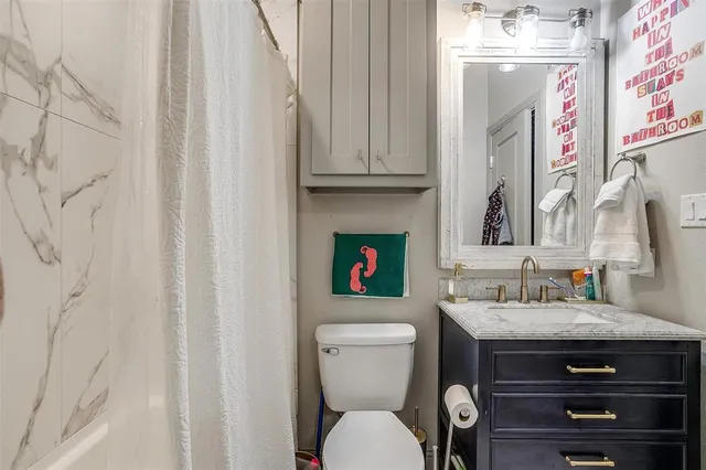 a bathroom with a toilet sink and mirror
