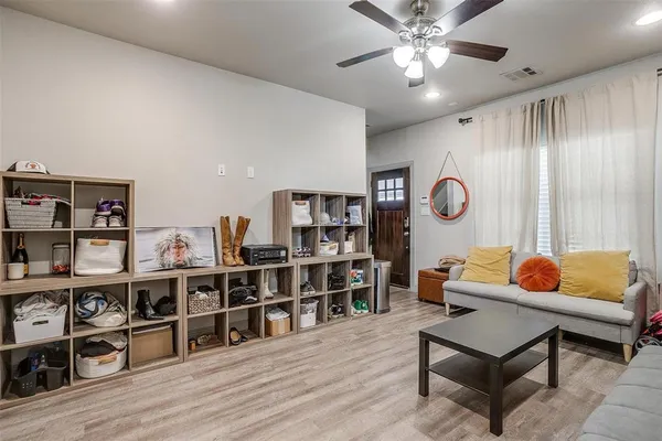 a living room with lots of furniture and a wooden floor