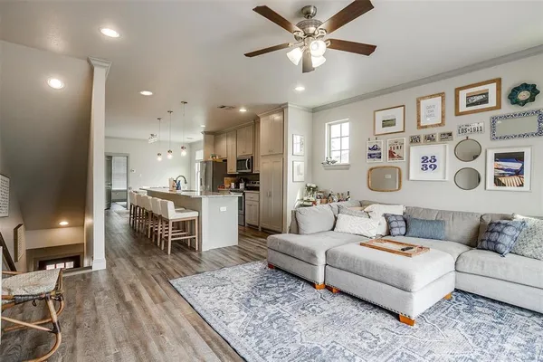 a living room with furniture and kitchen view