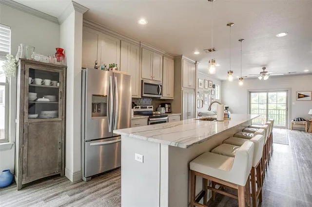 a kitchen with granite countertop a refrigerator and a sink