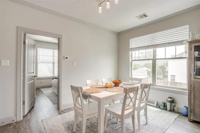 a dining room with furniture and window