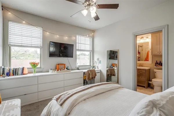 a bedroom with a bed a large window and a flat screen tv