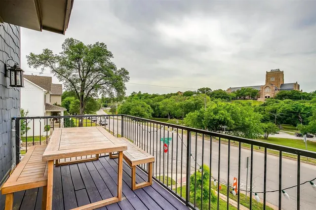 a view of a balcony with wooden floor