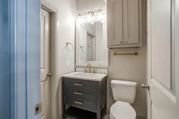 a bathroom with a toilet a sink and mirror