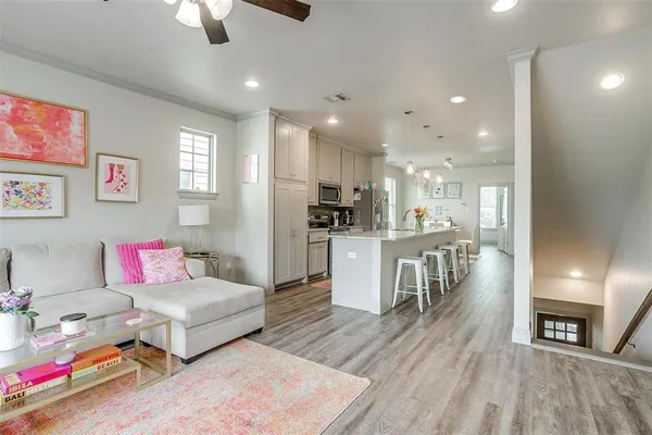 a living room with furniture and a wooden floor