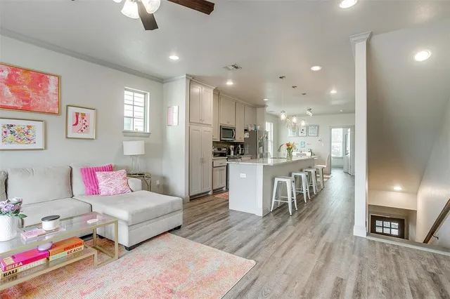 a living room with furniture and a wooden floor
