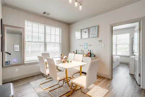 a dining room with furniture and wooden floor