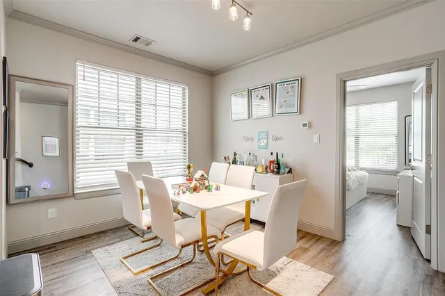 a dining room with furniture and wooden floor