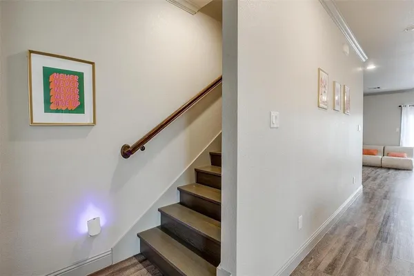 a view of entryway and hall with wooden floor