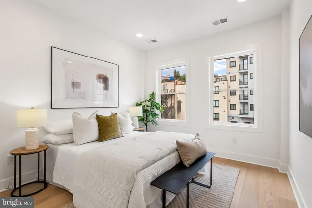 a bedroom with a bed and a painting on the wall
