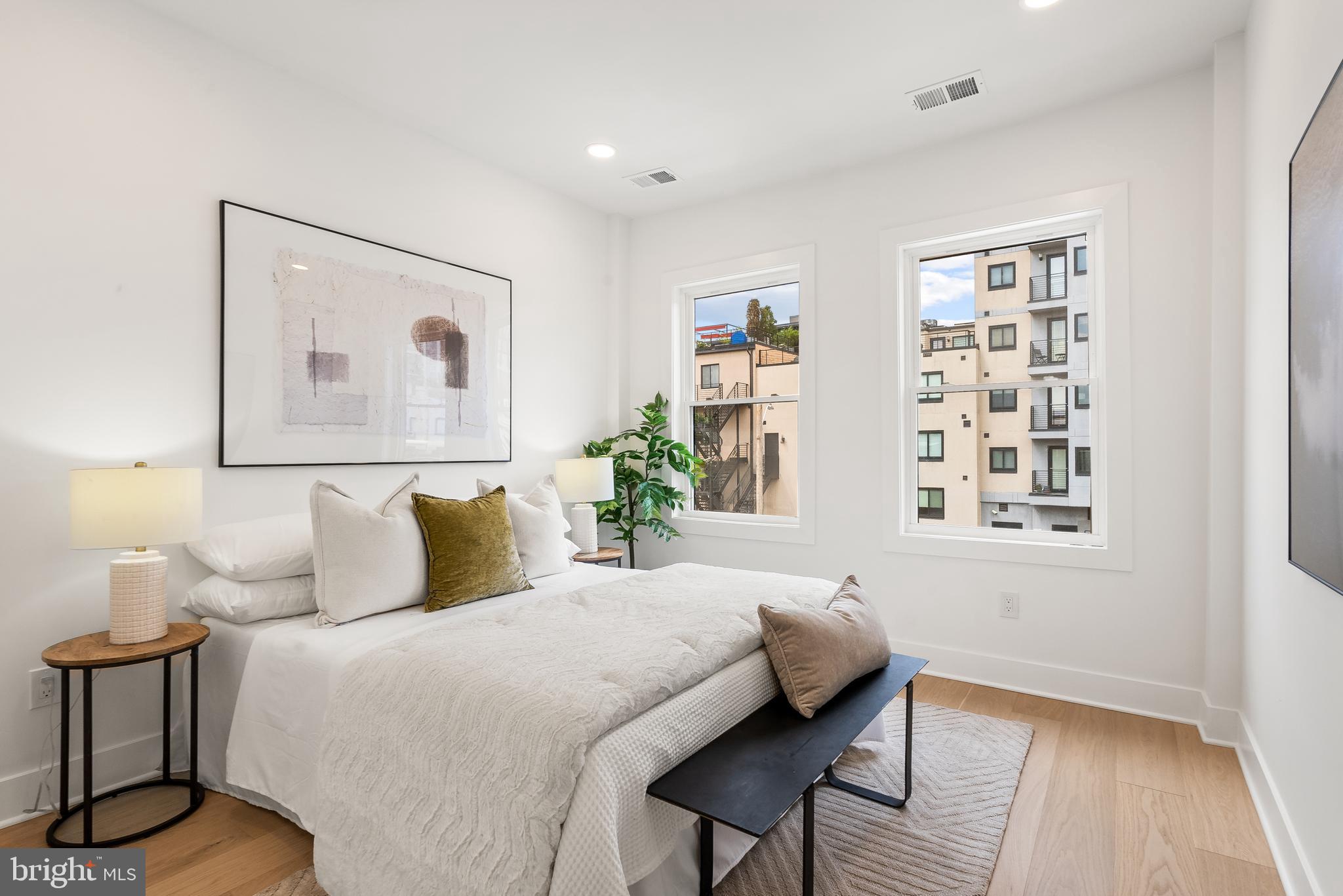 1932 11th Street Northwest Washington, DC 20001 - Photo 13 of 22 a bedroom with a bed and a painting on the wall
