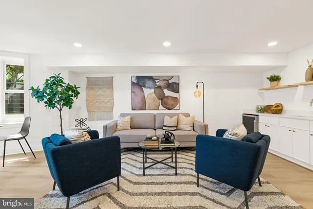 a living room with furniture and a potted plant