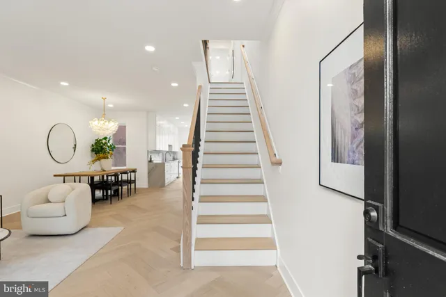 a living room with furniture flowerpot and white walls