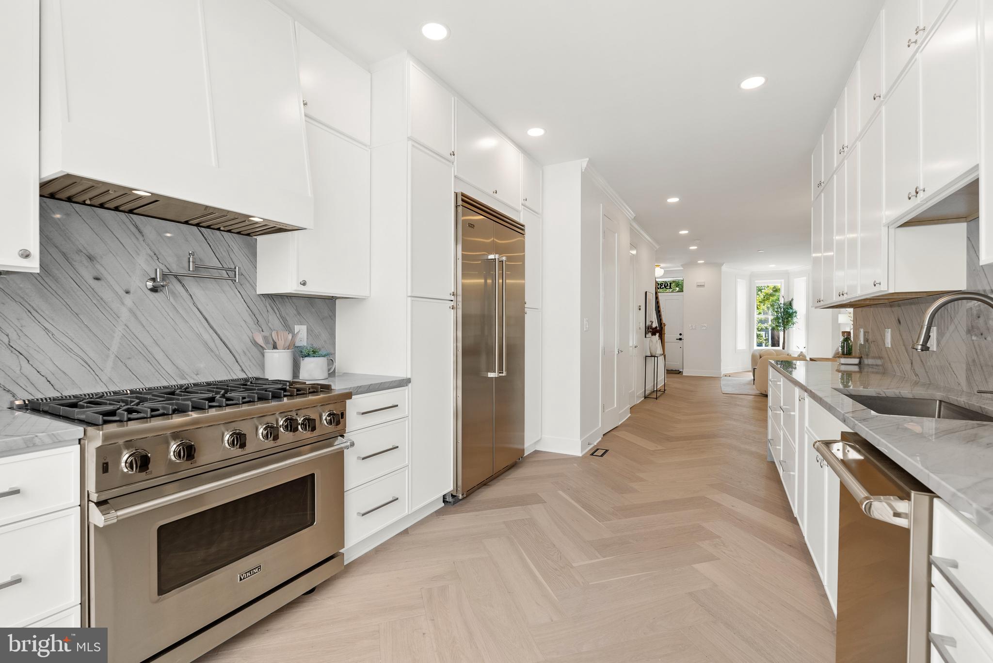 1932 11th Street Northwest Washington, DC 20001 - Photo 7 of 22 a kitchen with stainless steel appliances a stove a sink and a refrigerator