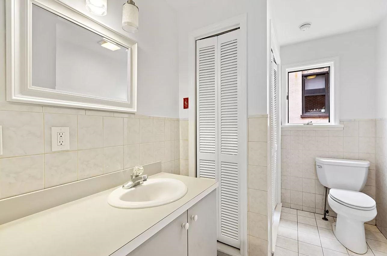712 Hudson Street Hoboken, NJ 07030 - Photo 11 of 16 a bathroom with a sink toilet and mirror