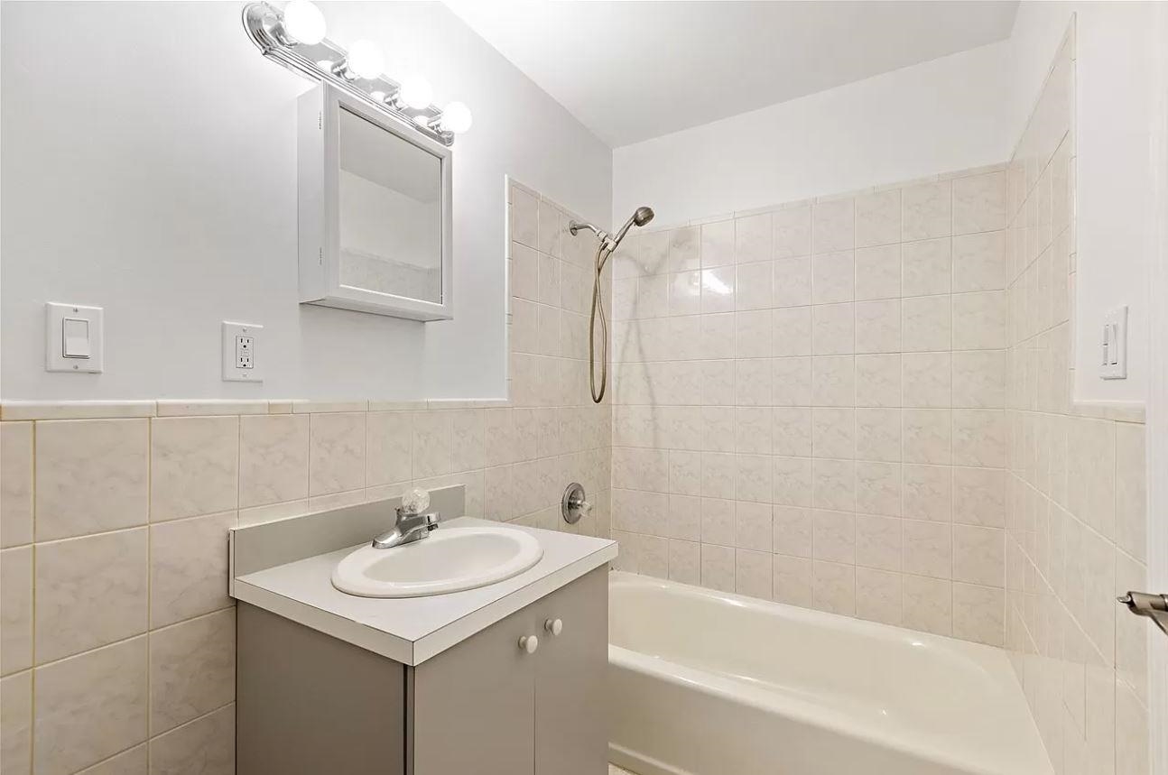 712 Hudson Street Hoboken, NJ 07030 - Photo 12 of 16 a bathroom with a sink a toilet and shower