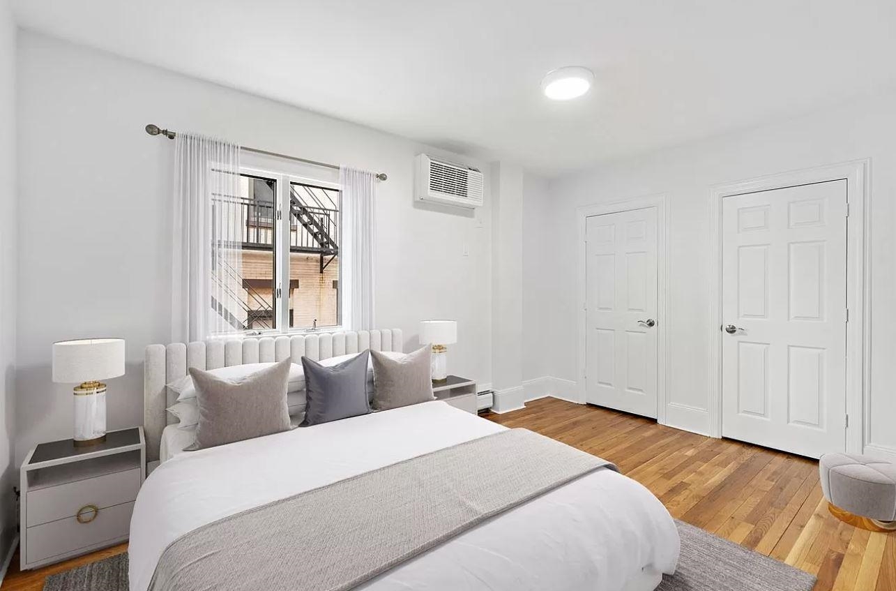 712 Hudson Street Hoboken, NJ 07030 - Photo 3 of 16 a bedroom with a bed and a window