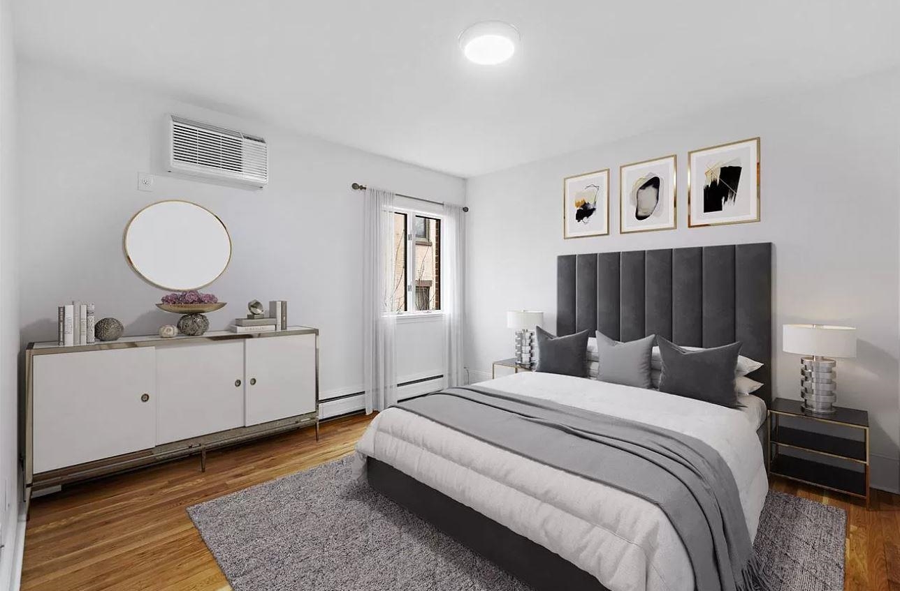 712 Hudson Street Hoboken, NJ 07030 - Photo 4 of 16 a bedroom with a bed and a chandelier
