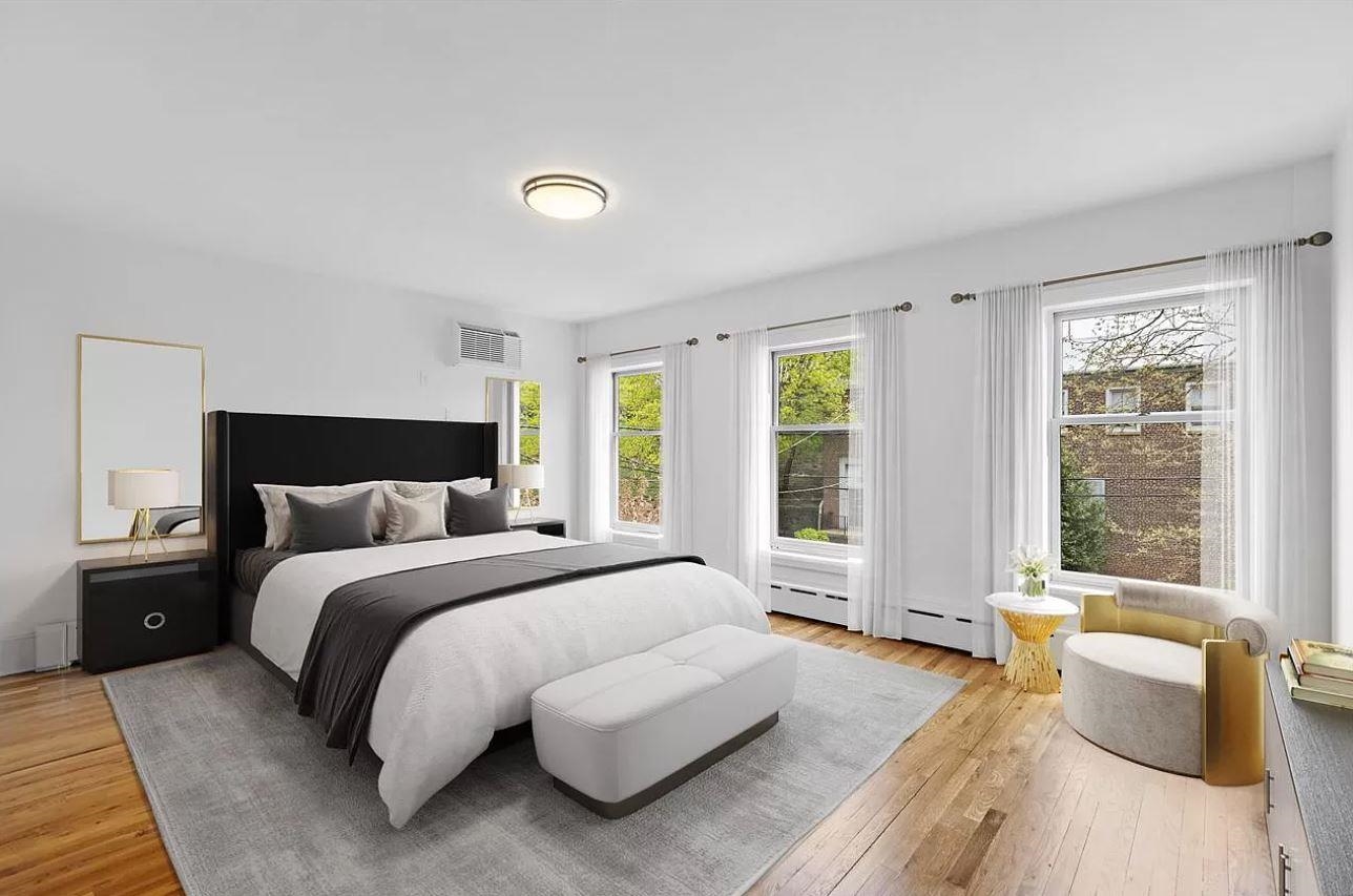 712 Hudson Street Hoboken, NJ 07030 - Photo 5 of 16 a spacious bedroom with a bed and wooden floor