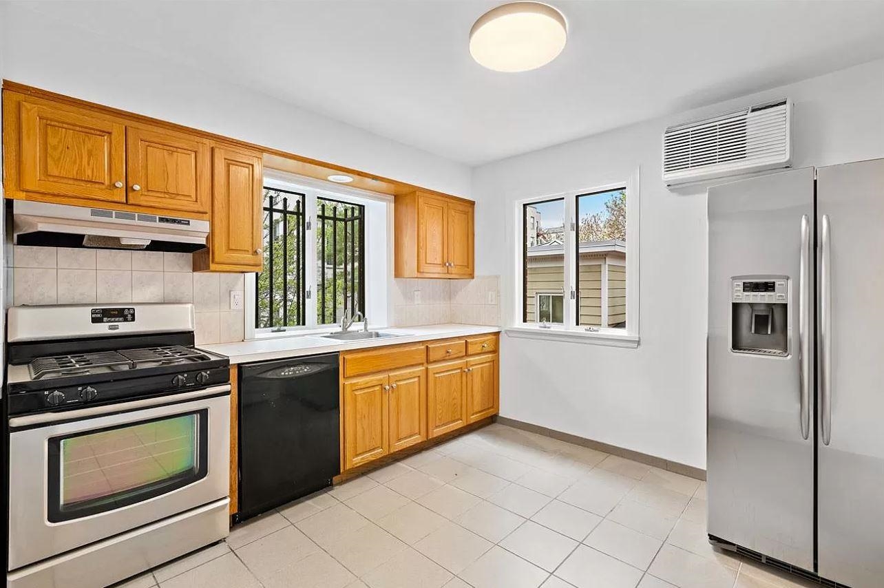 712 Hudson Street Hoboken, NJ 07030 - Photo 7 of 16 a kitchen with granite countertop stainless steel appliances a stove sink and microwave