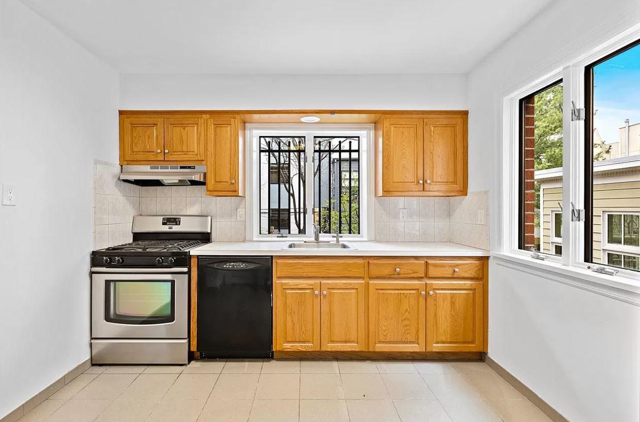 712 Hudson Street Hoboken, NJ 07030 - Photo 8 of 16 a kitchen with a stove sink and cabinets