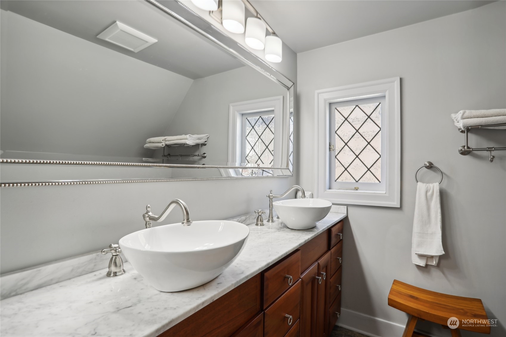 314 Halladay Street Seattle, WA 98109 - Photo 15 of 37 a bathroom with a granite countertop sink a toilet and a mirror