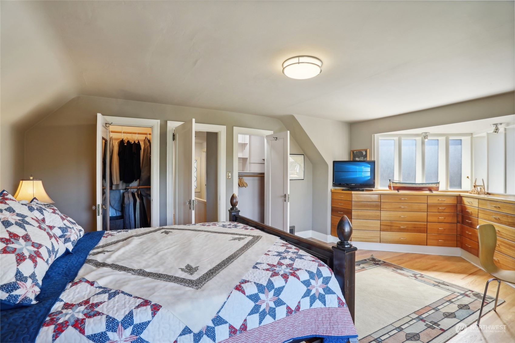 314 Halladay Street Seattle, WA 98109 - Photo 21 of 37 a bedroom with a bed and a large mirror