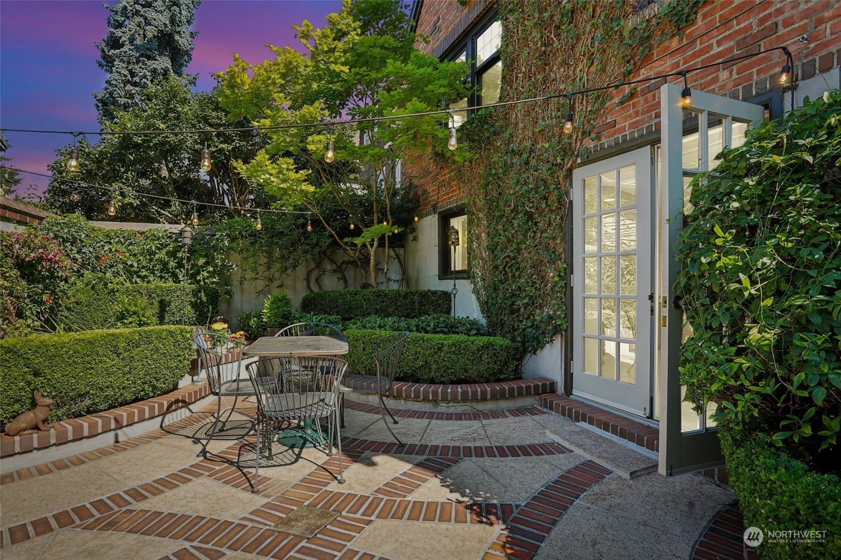 314 Halladay Street Seattle, WA 98109 - Photo 29 of 37 a view of a patio with table and chairs and potted plants