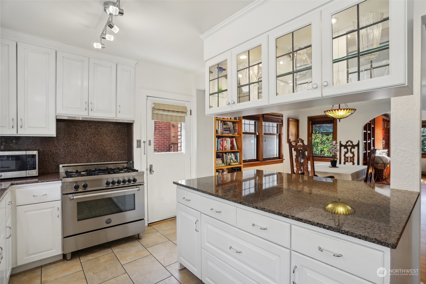 314 Halladay Street Seattle, WA 98109 - Photo 10 of 37 a kitchen with stainless steel appliances granite countertop a stove and cabinets