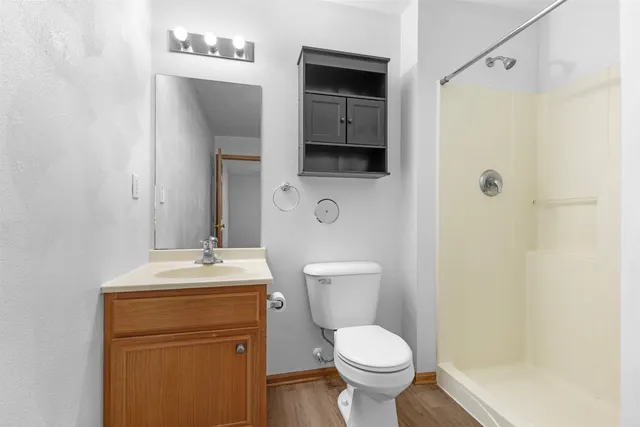 a bathroom with a toilet sink shower and mirror