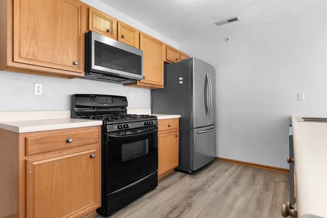 a kitchen with a stove microwave and refrigerator