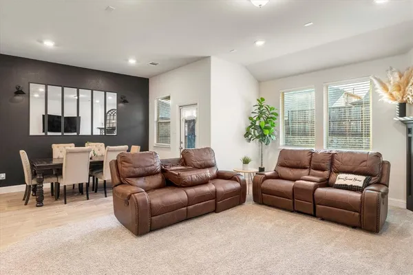 a living room with furniture and a potted plant