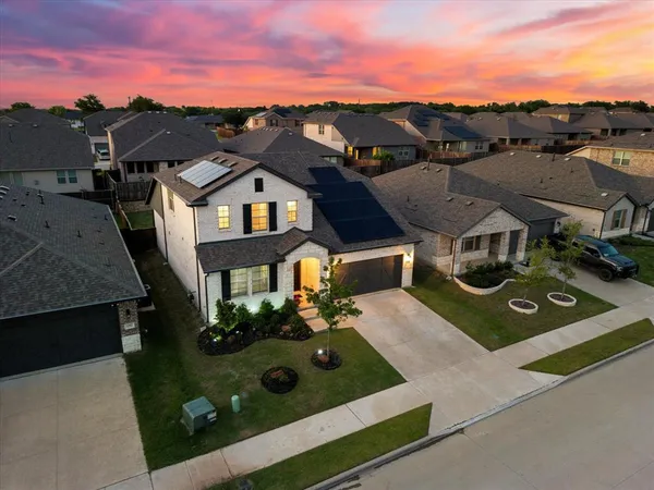 an aerial view of a house with a yard