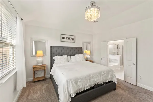 a bathroom with a sink a potted plant and a mirror