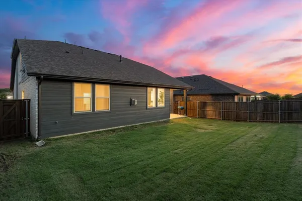 a house view with a sitting space and garden