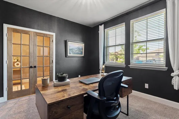 a kitchen with stainless steel appliances granite countertop a refrigerator a stove top oven a sink dishwasher a dining table and chairs with wooden floor