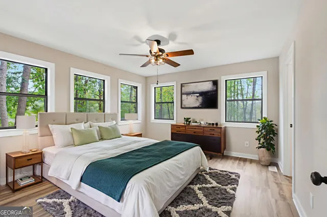 a view of empty room with wooden floor and window