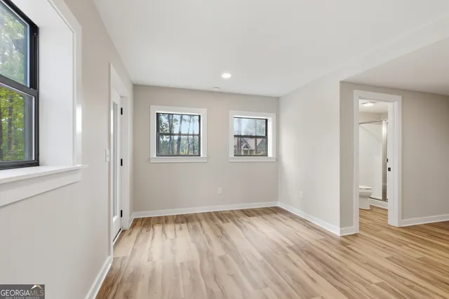 a view of entryway and hall with wooden floor