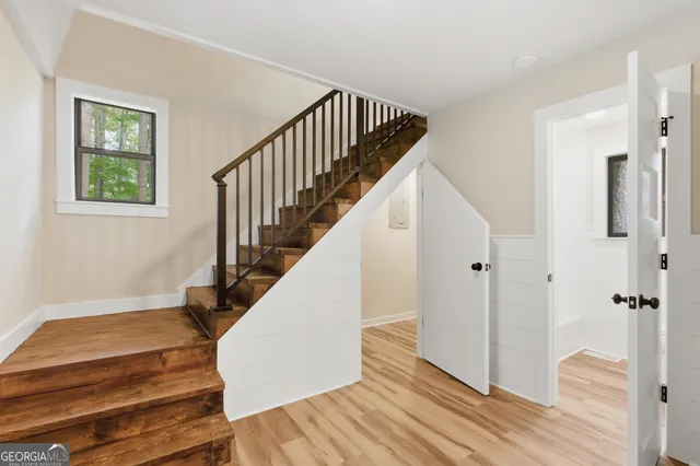 a view of entryway with wooden floor and stairs