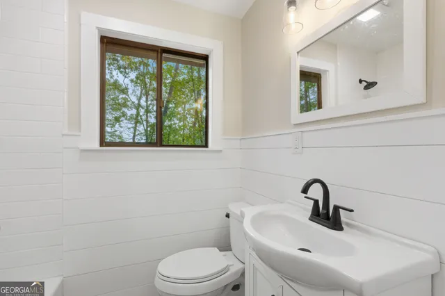 a view of hallway with wooden floor and stairs