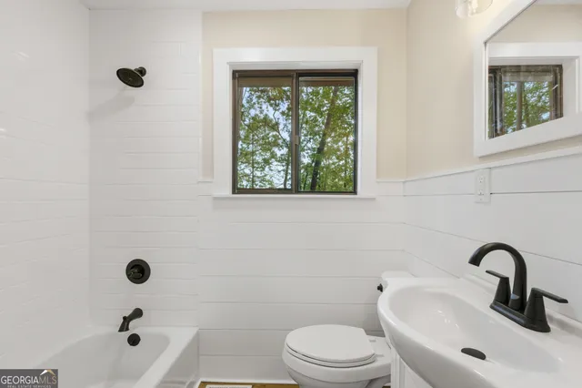 a view of a bedroom with a bed and a window