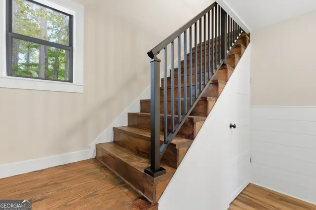 a view of a livingroom with a ceiling fan and window