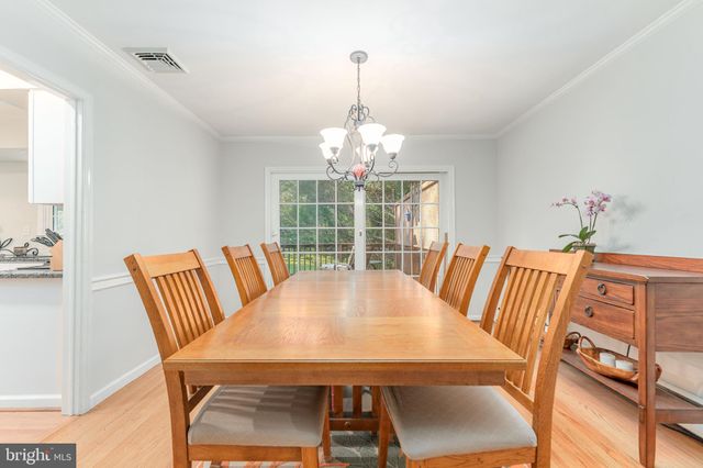 a kitchen with granite countertop white cabinets and a sink