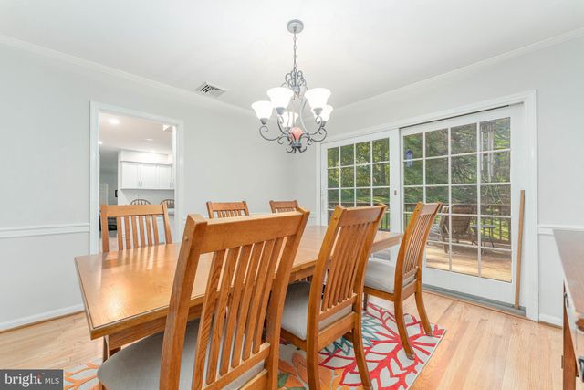 a kitchen with white cabinets and refrigerator