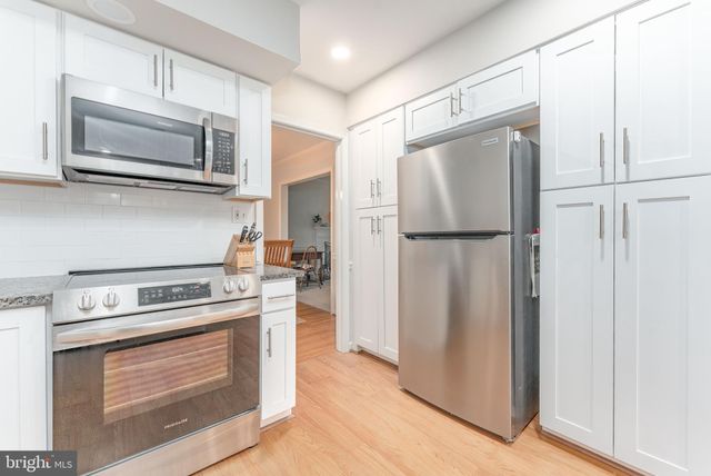 a bathroom with a sink mirror and toilet