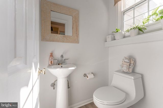a bedroom with a bed and a flat tv screen on dresser