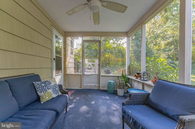 a view of an empty room with closet and a window