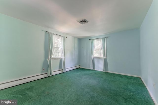 an empty room with a projector and painted walls